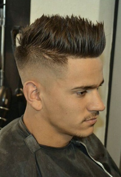 A barbershop photograph of a young white male with spiky hair styled with a short fade haircut